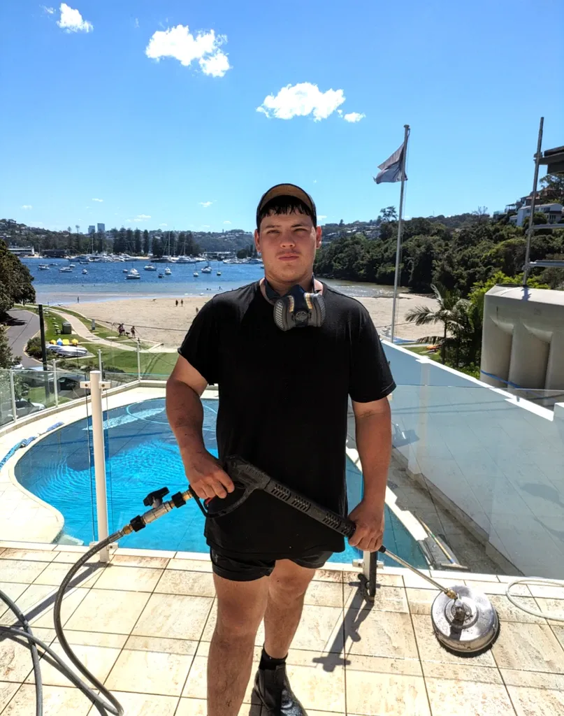 Elite Property Exterior Cleaning team member with soft washing equipment